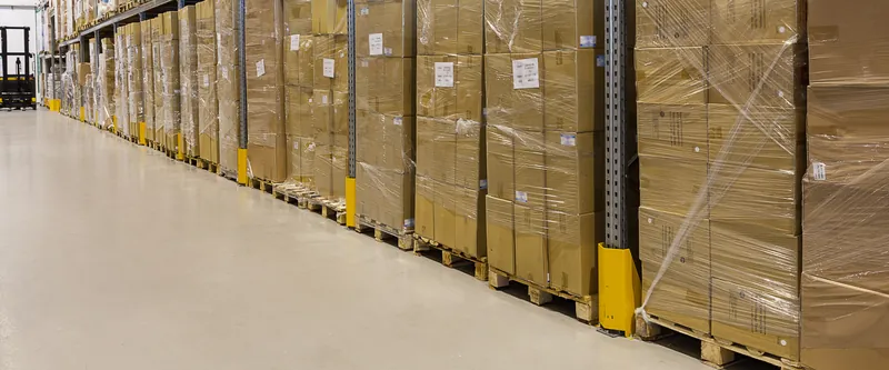 Wrapped pallets of finished parts ready for dispatch in a warehouse